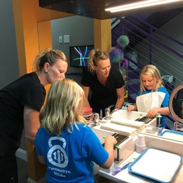 Maile-with-Young-Girl-Brushing